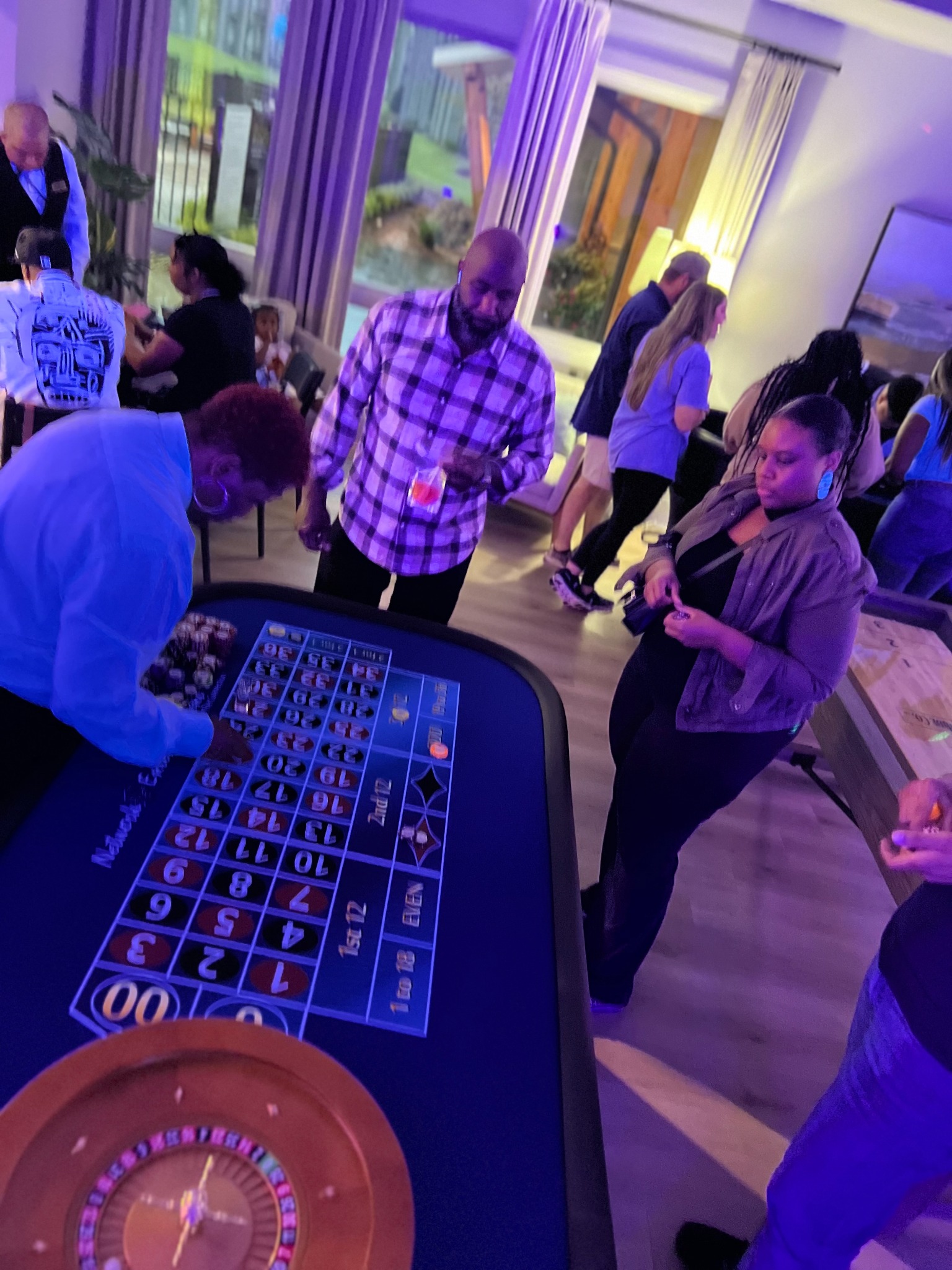 Guests gathered at a roulette table